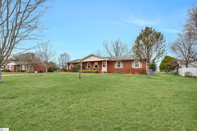 ranch-style home with crawl space, fence, a front lawn, and brick siding