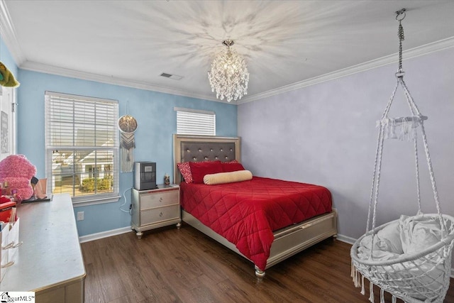 bedroom with ornamental molding, wood finished floors, visible vents, and baseboards