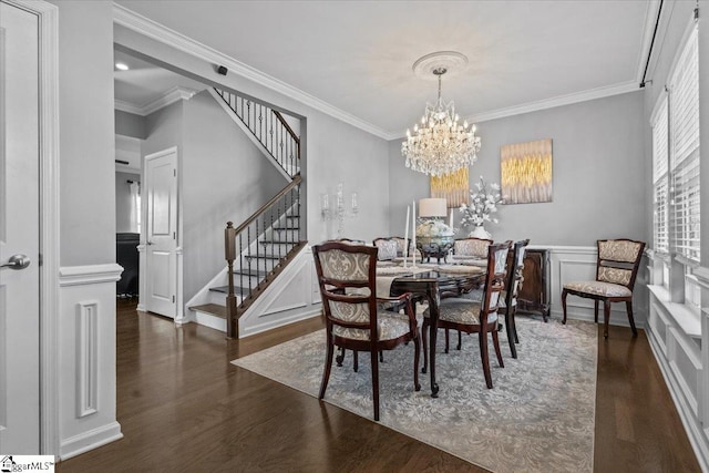 dining room featuring ornamental molding, stairway, wainscoting, and wood finished floors