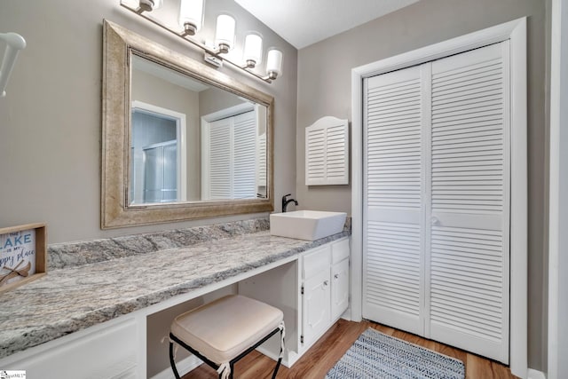 full bath featuring an enclosed shower, wood finished floors, a closet, and vanity