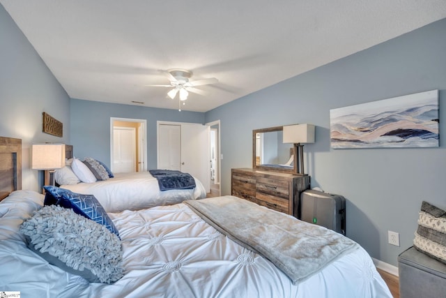 bedroom featuring a closet, ceiling fan, baseboards, and wood finished floors