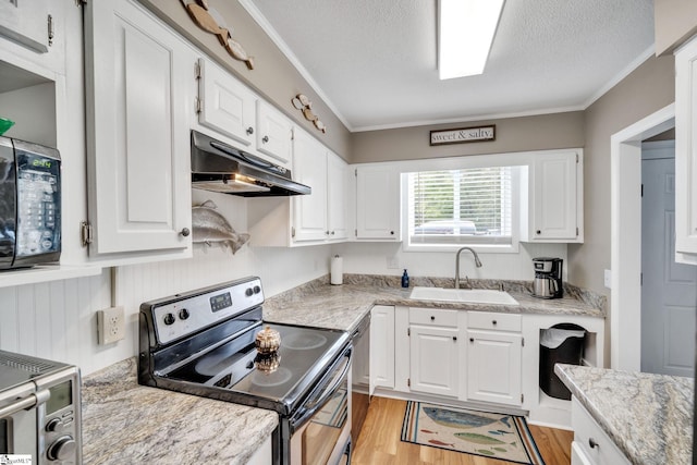 kitchen with ornamental molding, stainless steel appliances, under cabinet range hood, white cabinetry, and a sink