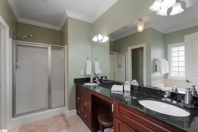 bathroom featuring a stall shower, crown molding, a sink, and tile patterned floors