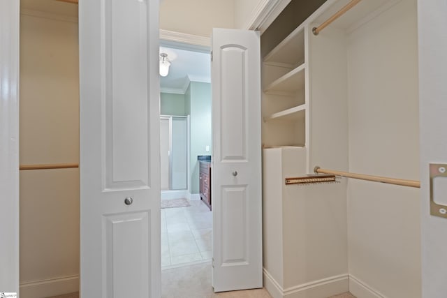 spacious closet with light tile patterned floors