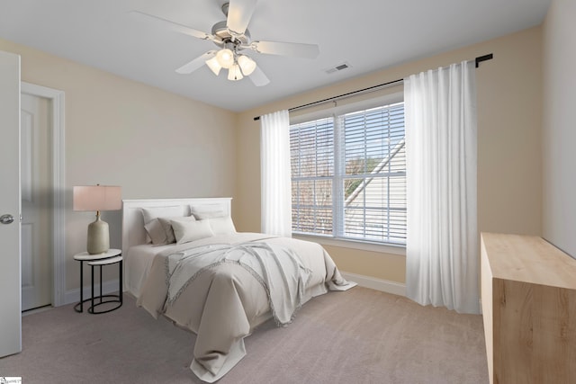 bedroom featuring ceiling fan, carpet, visible vents, and baseboards