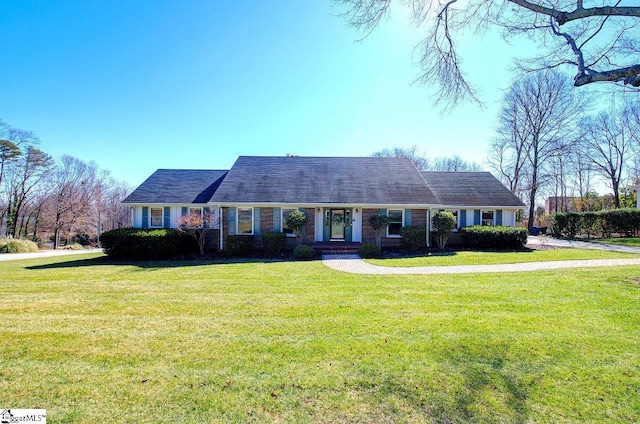 ranch-style home with brick siding and a front yard