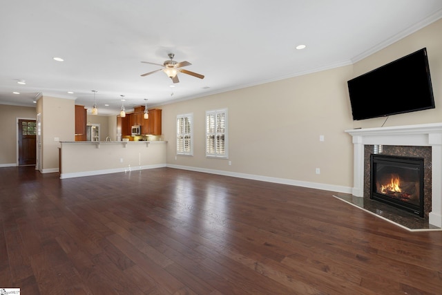 unfurnished living room with crown molding, dark wood-style flooring, and a fireplace