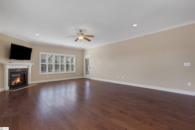 unfurnished living room with dark wood-style floors, a fireplace, baseboards, and ornamental molding