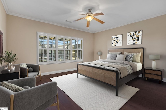 bedroom featuring baseboards, visible vents, dark wood finished floors, and crown molding