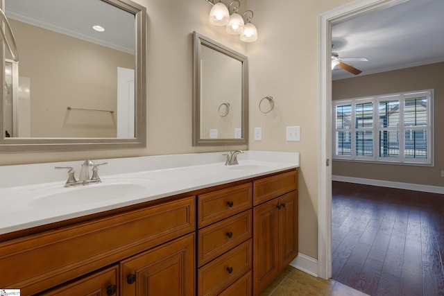 full bathroom featuring double vanity, crown molding, ceiling fan, and a sink