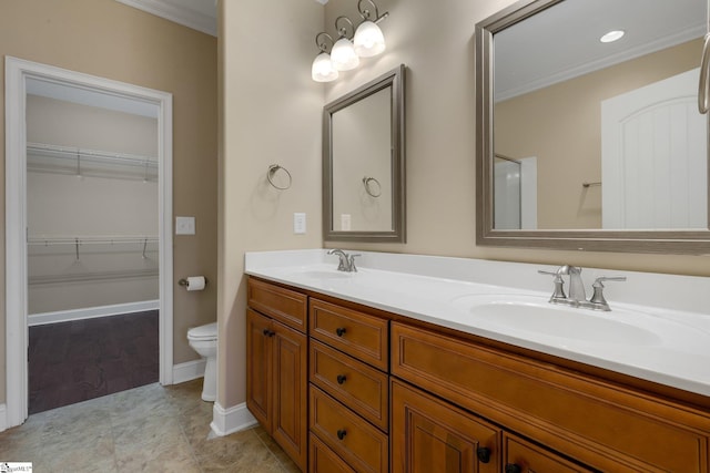 bathroom with double vanity, crown molding, and a sink