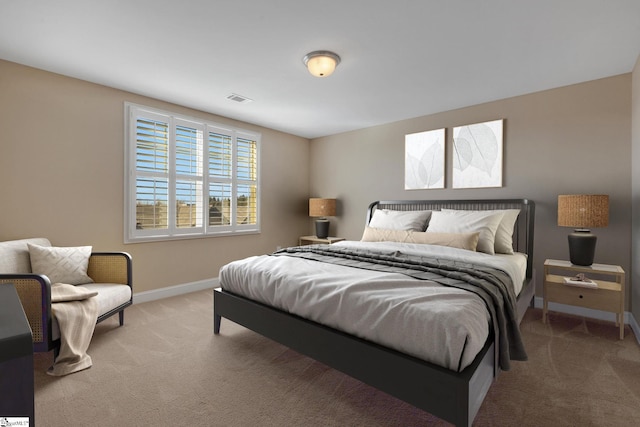 carpeted bedroom featuring baseboards and visible vents