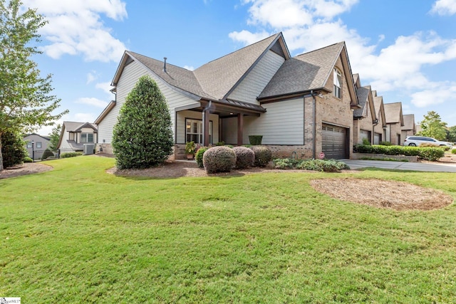 view of side of home with roof with shingles, brick siding, a lawn, an attached garage, and driveway