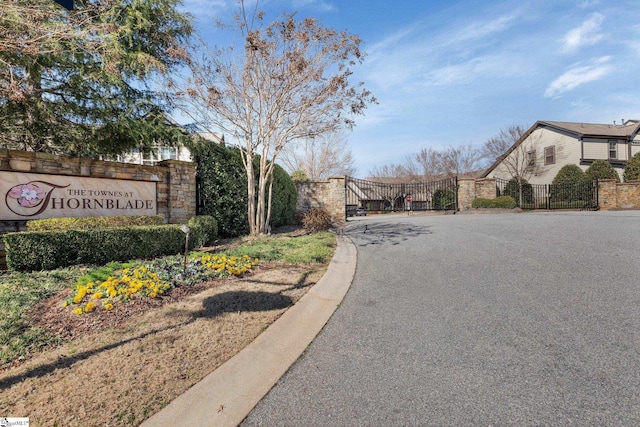 view of road featuring a gate and a gated entry