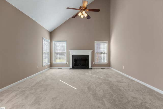 unfurnished living room with a wealth of natural light, baseboards, and carpet