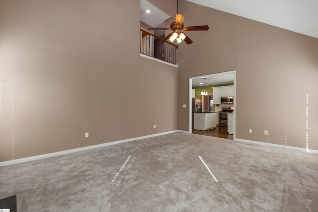 unfurnished living room with high vaulted ceiling, recessed lighting, carpet floors, a ceiling fan, and baseboards