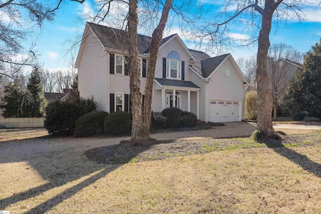 view of front of property with driveway, a front lawn, an attached garage, and fence