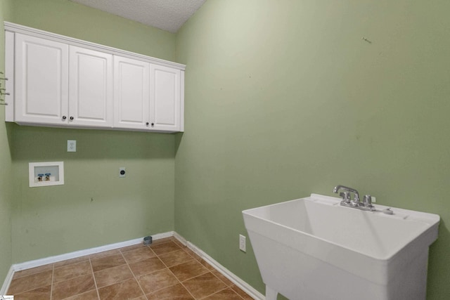 laundry area with a textured ceiling, washer hookup, a sink, cabinet space, and electric dryer hookup