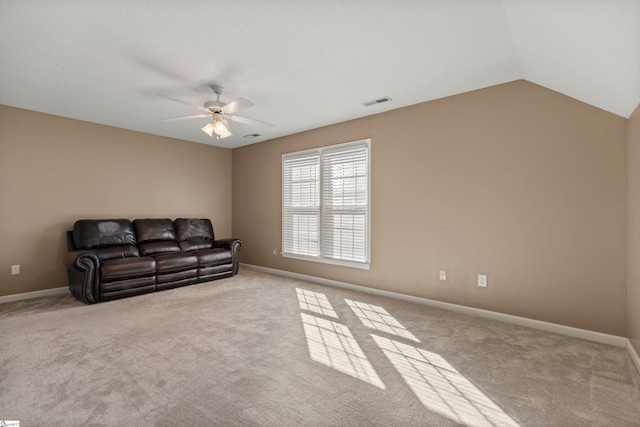 carpeted living room with vaulted ceiling, visible vents, ceiling fan, and baseboards