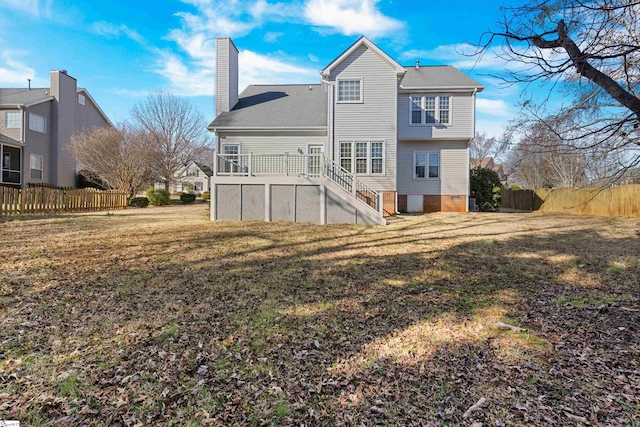 back of property with stairs, a yard, a chimney, and fence