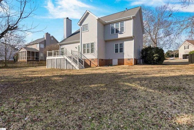 back of property with a lawn, a chimney, stairway, crawl space, and cooling unit