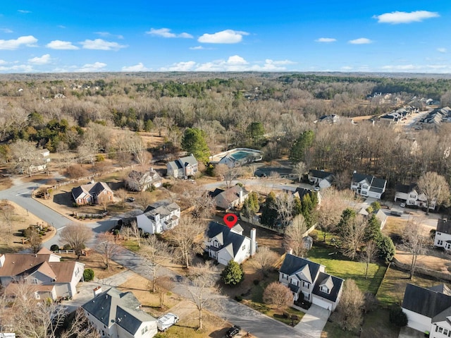 bird's eye view featuring a wooded view and a residential view