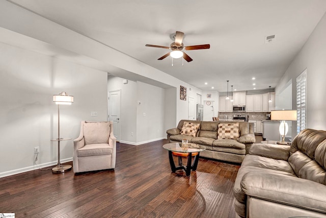 living area with recessed lighting, a ceiling fan, visible vents, baseboards, and dark wood-style floors