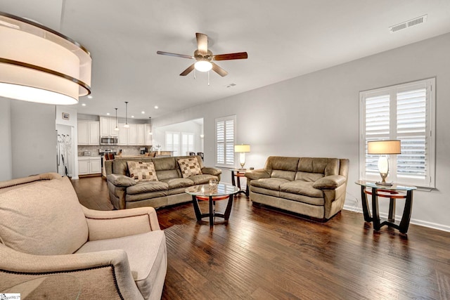 living room with baseboards, visible vents, a ceiling fan, dark wood-style flooring, and recessed lighting