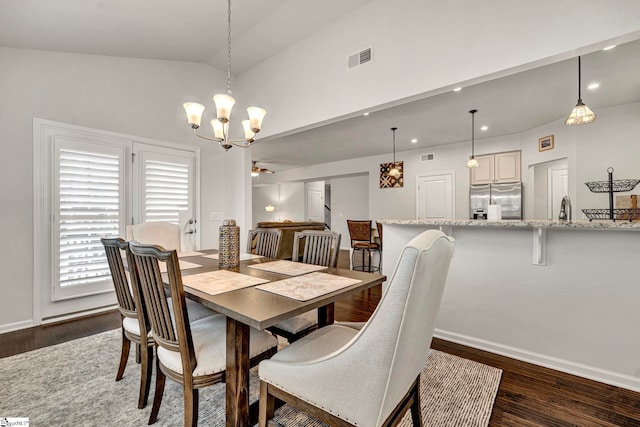 dining space with dark wood-style floors, lofted ceiling, visible vents, and baseboards