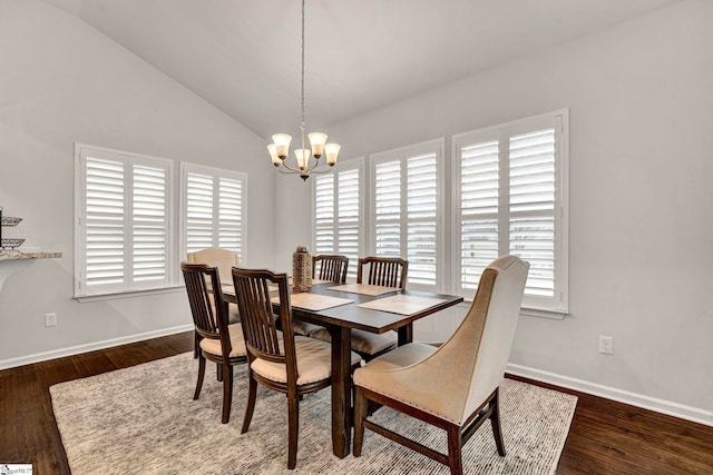 dining space with an inviting chandelier, baseboards, vaulted ceiling, and wood finished floors