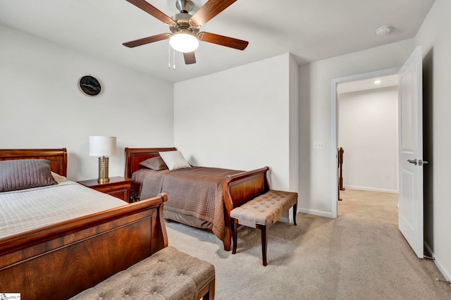 bedroom with baseboards, a ceiling fan, and light colored carpet