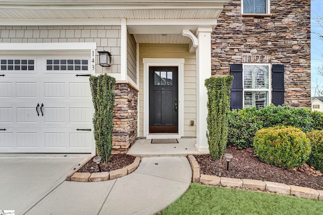 entrance to property with stone siding and an attached garage