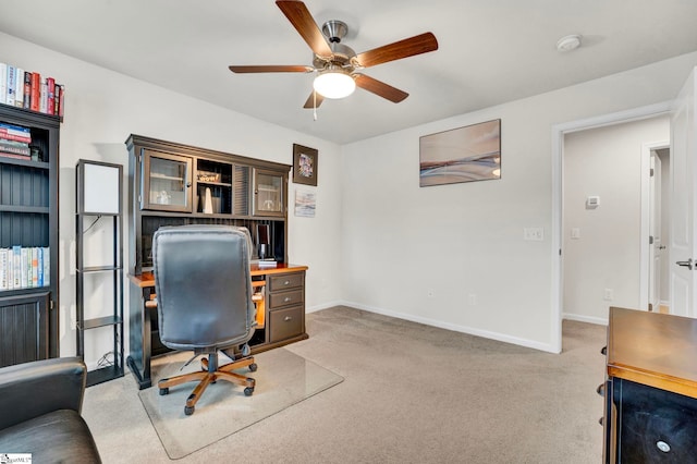 office featuring ceiling fan, baseboards, and carpet flooring