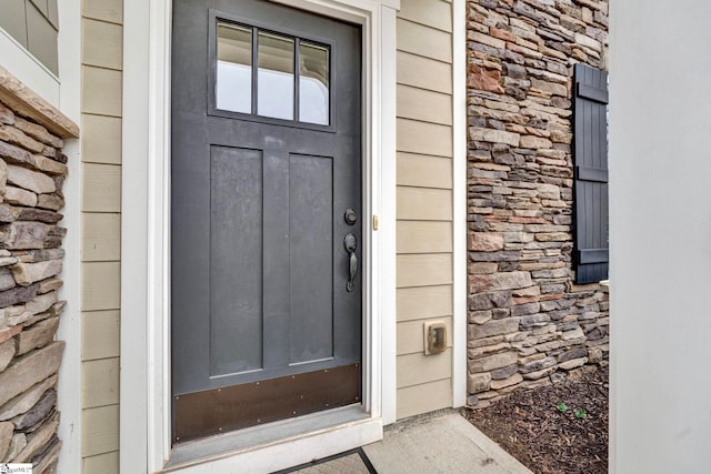 view of exterior entry featuring stone siding