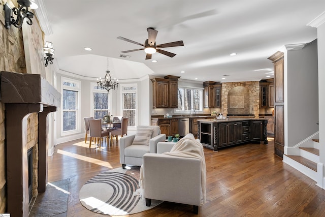 living room featuring a fireplace, dark wood-type flooring, and crown molding