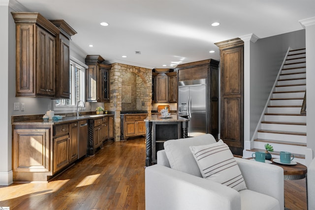 kitchen with a kitchen island, dark wood-type flooring, stainless steel appliances, crown molding, and recessed lighting