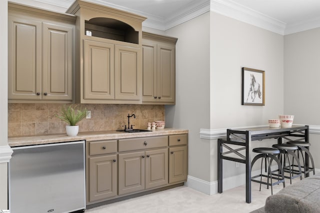 kitchen featuring baseboards, light countertops, ornamental molding, backsplash, and stainless steel fridge
