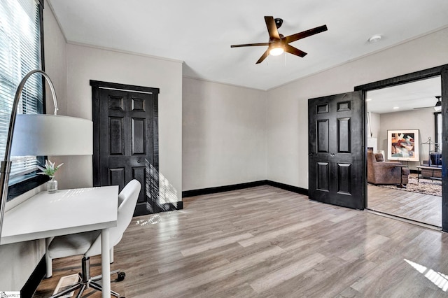 office space with lofted ceiling, ceiling fan, baseboards, and wood finished floors