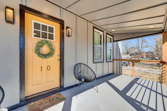 doorway to property featuring a porch and board and batten siding