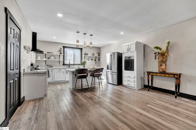 kitchen featuring a breakfast bar, range hood, appliances with stainless steel finishes, and open shelves