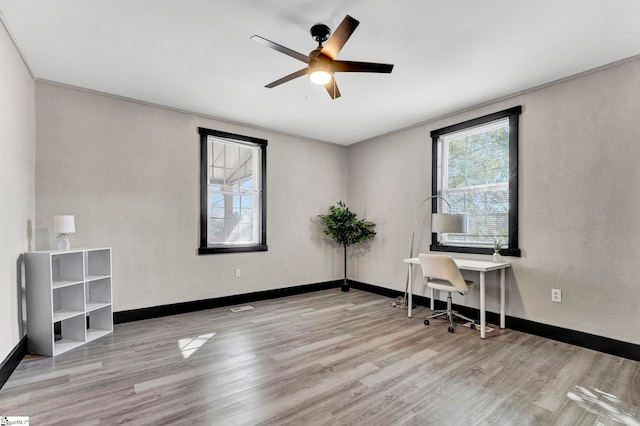 office with wood finished floors, a ceiling fan, and baseboards