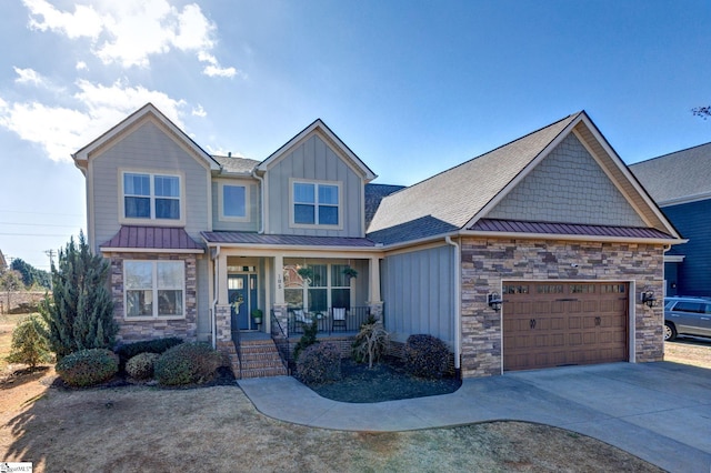 craftsman-style home featuring board and batten siding, covered porch, driveway, and a standing seam roof