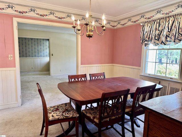 carpeted dining space featuring radiator, wainscoting, crown molding, and a notable chandelier