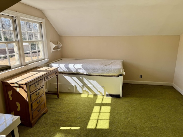 carpeted bedroom with vaulted ceiling and baseboards