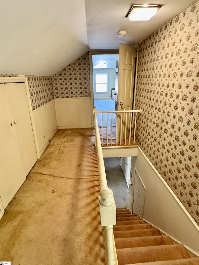 bonus room featuring lofted ceiling, light carpet, and wallpapered walls