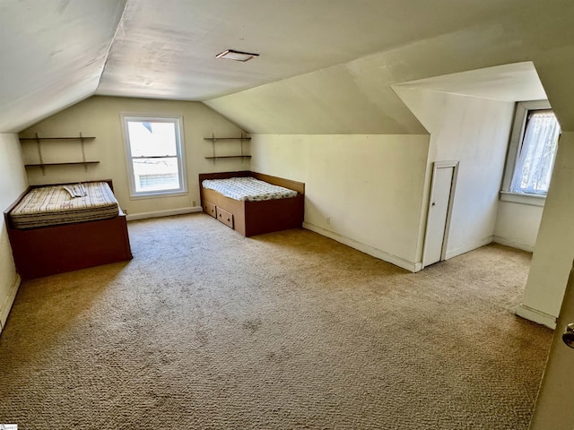 bonus room featuring lofted ceiling and carpet floors