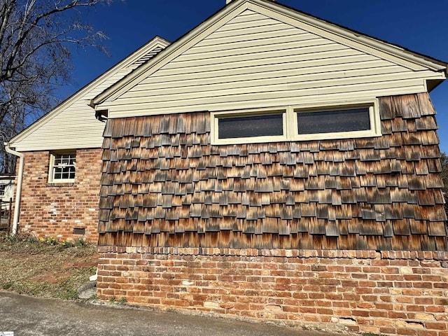 view of side of home with brick siding