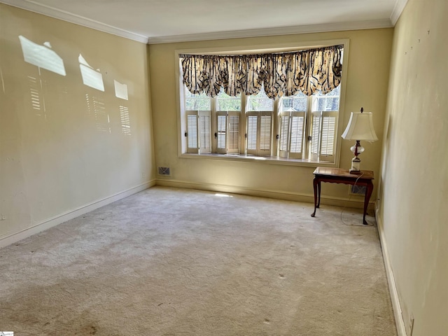 carpeted empty room featuring baseboards and ornamental molding