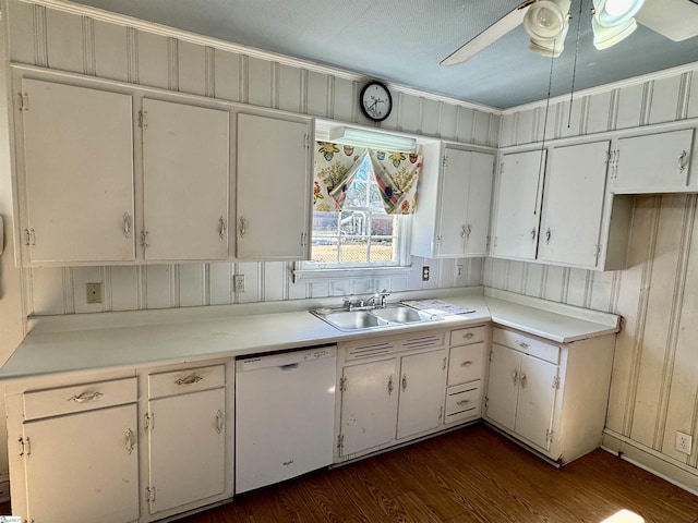 kitchen featuring dark wood-style floors, light countertops, white dishwasher, and a sink