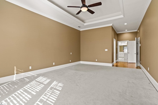 unfurnished room with baseboards, carpet, a tray ceiling, crown molding, and recessed lighting